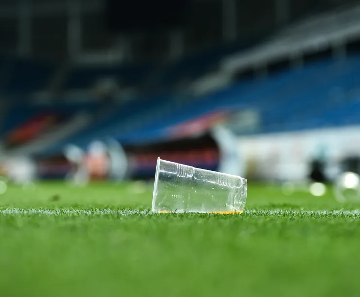 Plastic cup in a football field