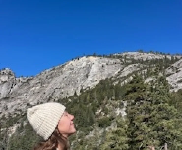 Young woman looking up at the view of Yosemite Valley