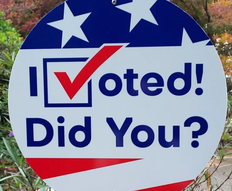 A circular sign with red, white and blue art and the words "I Voted! Did You?"