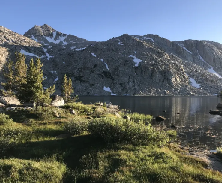 Grass and Lake in front of rugged mountains