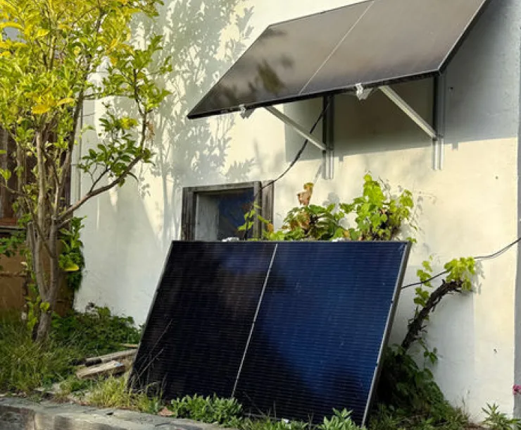 Plug-in solar panels against a house