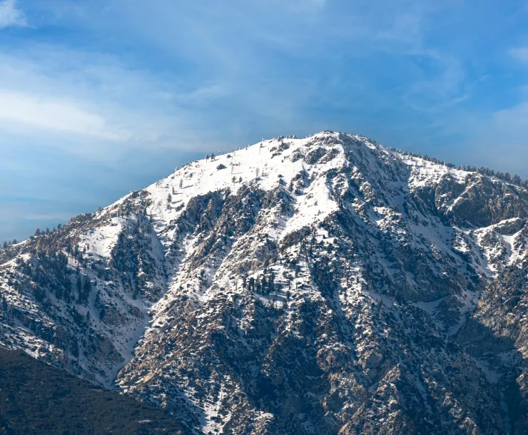Majestic view of the snowcapped San Gabriel Mountains under a clear blue sky in winter