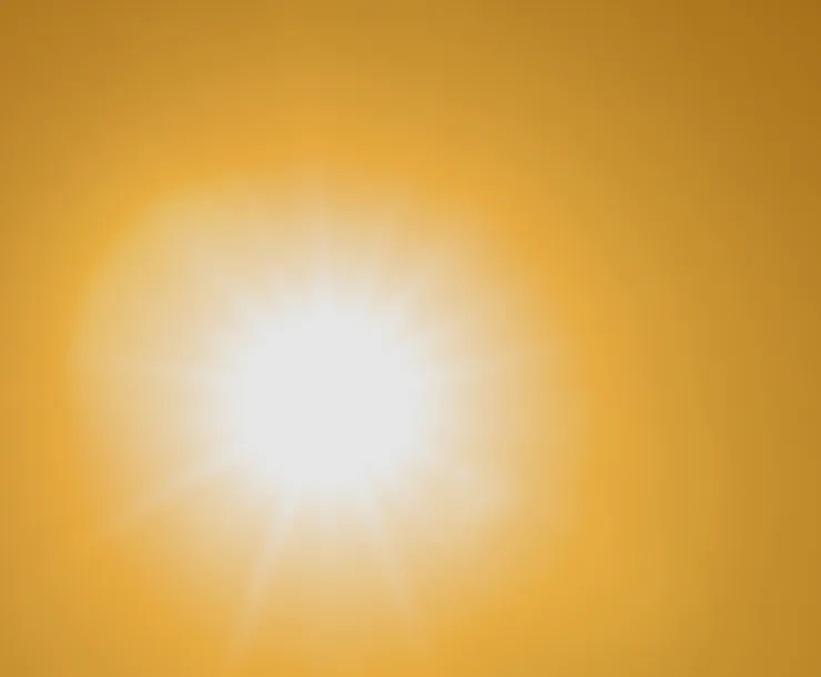 A blurry photo looking directly into the sun in the sky