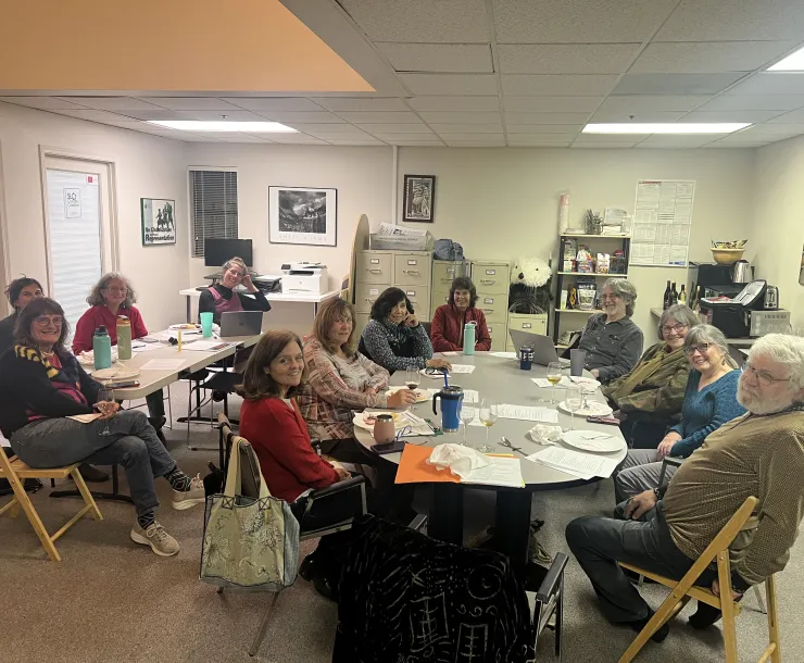 Chapter leaders sitting around tables at their December 2025 meeting