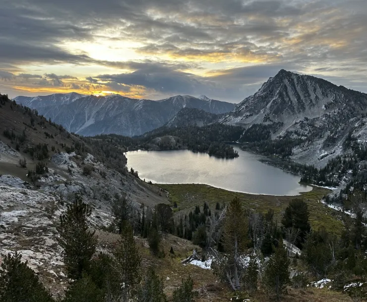 A photo of an alpine lake at sunset