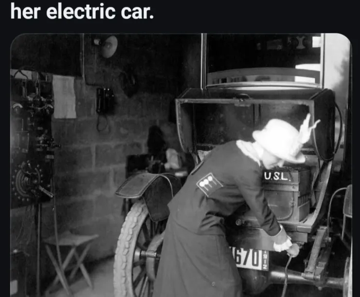 A 1912 shot of a woman plugging in her electric car.