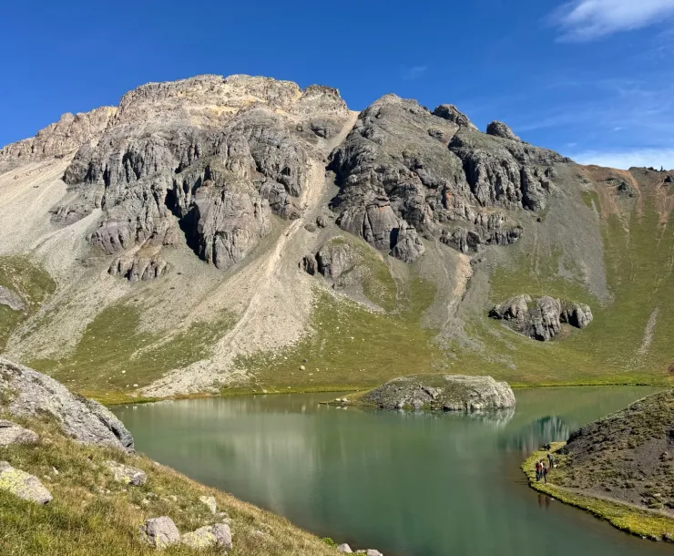 Scenic image of a mountain behind a blue/green lake 