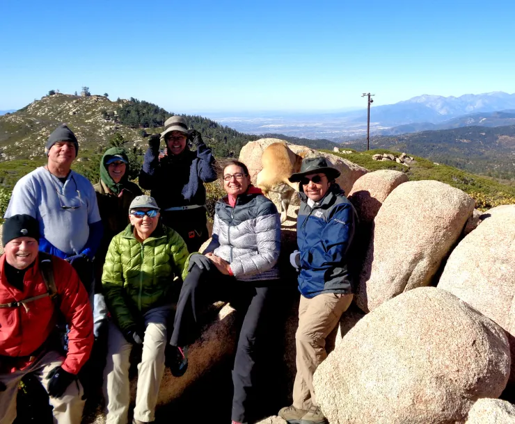 Members of the mountain group posing for a photo on boulders near Slide Peak, looking towards Keller Peak. Roadless Area in the San Bernardino National Forest. photo by Karla Kellems