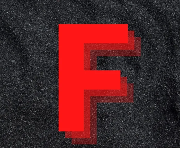 A red letter F is superimposed on a background of coal particles