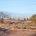 SRP Gas Plant in Coolidge Arizona during the day. Haze pollution blurs the mountains in the background