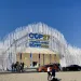 Pictured is the entrance to the COP27 climate conference, featuring a white archway with the words COP27 Sharm El-Sheikh Egypt 2022.