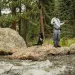 Eeland Stribling and his dog, Wilfred, stand on a rock while fishing in Bear Creek outside of Denver, Colorado..