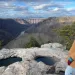 Diamon Clark turns to look at the camera at a lookout point on Long Point Trail at New River Gorge National Park.