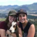 Two women and their basset hound dog in front of mountains in Colorado