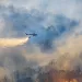 Helicopter dropping water on forest fire. | Photo by Toa55/iStock