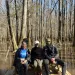 Three friends sit on a bench in Congaree National Park.