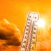 Thermometer under an image of the sun showing high temperatures. 