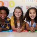 5 kids facing forward smiling for a photo 