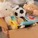 Box filled with kids plush toys and others. 