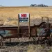 A sign opposing proposed carbon-capture pipelines is seen on a manure spreader