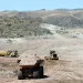 Construction trucks haul and push dirt at the Shafter Mine Project.