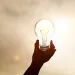 Hand holding a lightbulb 