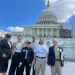 Six Sierra Club activists stand in front of the United States Capitol Building.