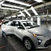 An assembly line worker looks over a 2023 Chevrolet Bolt EUV