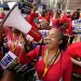 United Auto Workers member Tasha Johnson leads a chant while attending a rally in Detroit.