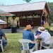A group of veterans sit at tables watching a stage performance in Washington Oaks Gardens State Park in Florida on Earth Day.