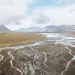 A shallow river with many tributaries runs through the Arctic National Wildlife Refuge