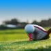 golf club in front of a golf ball on a tee