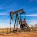 A oil rig in a field.