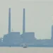 An image of the Brandon Shores coal plant's smoke stacks with a boat in the foreground