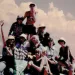 Ten women pose on a rock high up in the Sierra. One holds a Sierra Club banner.