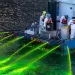 People on a boat spray green dye into the Chicago River