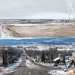The Colstrip power plant sits in an area of snow-covered open land.