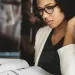 Photo of a woman reading a newspaper