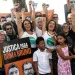Activists raise their fists and hold a sign