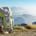 Hiking equipment. Backpack and boots on top of the mountain. | Photo by Drepicter/iStock