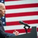 president biden in front of an american flag