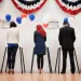 Voters voting in polling place.