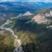 An aerial view of the Brooks Range, with a stream flowing through a valley