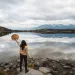 A warrior woman standing in front of a lake.