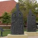 A portion of Preston Jackson's 2009 "Acts of Intolerance" statue in Springfield, Illinois' Union Square. The statue, in the form of two chimney columns that are all that remains from a burned-out building, commemorates the deadly Springfield race riot of 1908, in which white mobs attacked African-American residents, burned several homes, and lynched two black men.