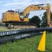 Geothermal construction begins with the installation of main piping at Farley Lot