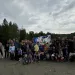 A group of people pose with a banner