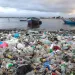 Litter and debris blanket the shoreline in Cap-Haitien, Haiti.