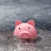 A pink piggy bank drowning in a flood
