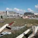 Tyndall Air Force Base is littered with debris after Hurricane Michael. A hangar's roof is missing tiles. Metal pieces, including a Stop sign, are on the ground.